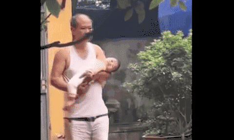 Ru cháu ngủ, gương mặt ông nội dần mất đi nụ cười hào hứng lúc ban đầu